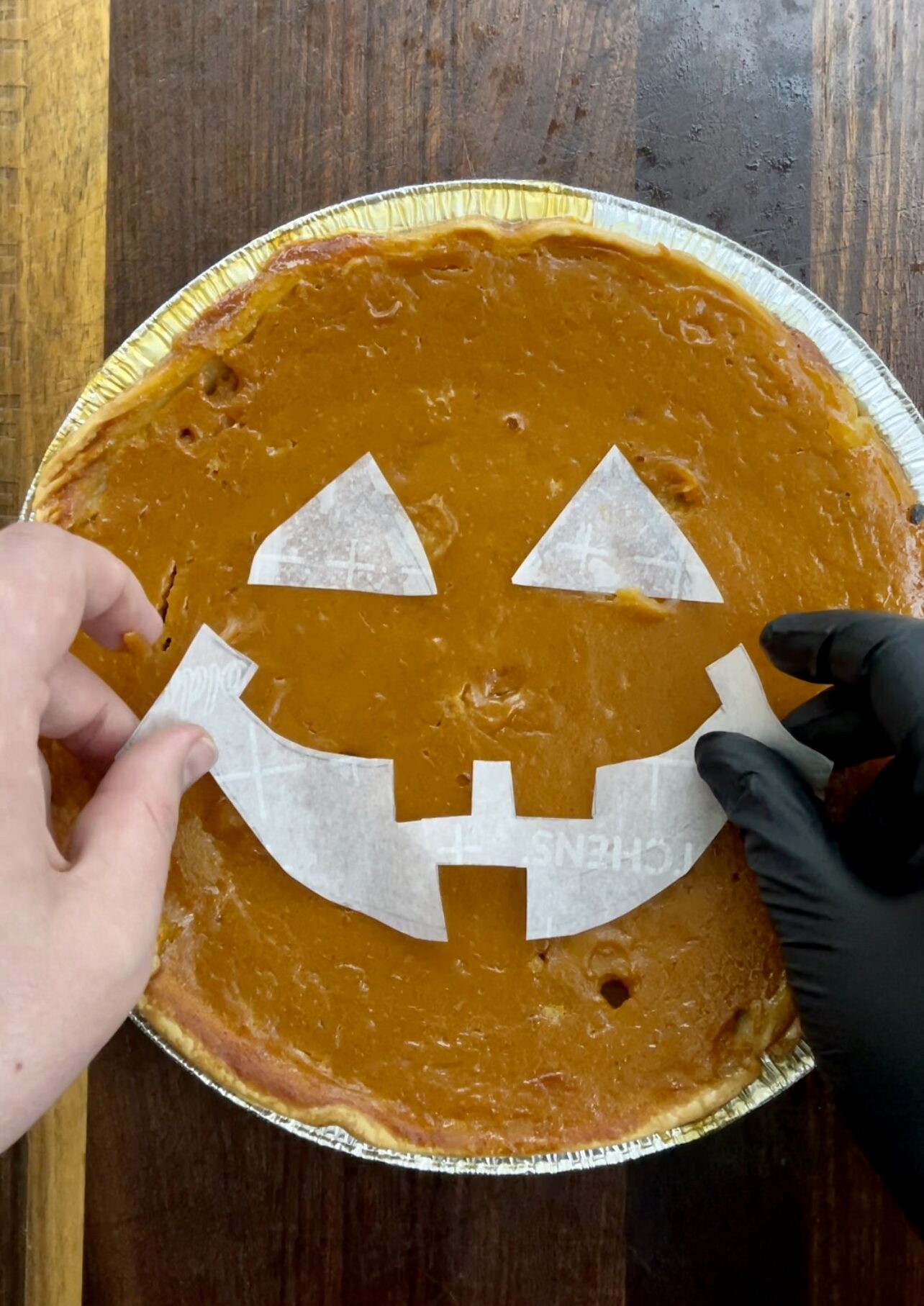 Adding the paper stencil to the smoked pumpkin pie
